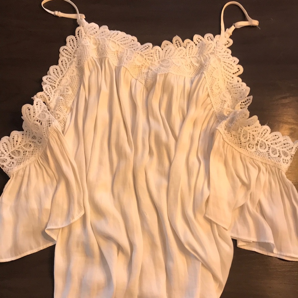 Flowy white off-the-shoulder blouse.